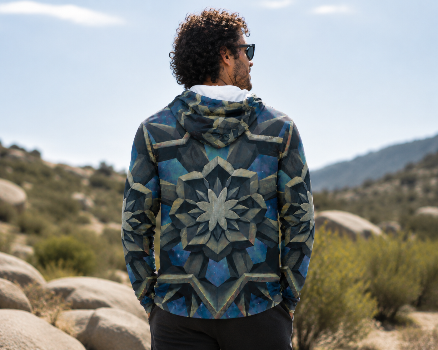 Person wearing UV hoodie with "dissolve" painting printed all over entire hoodie